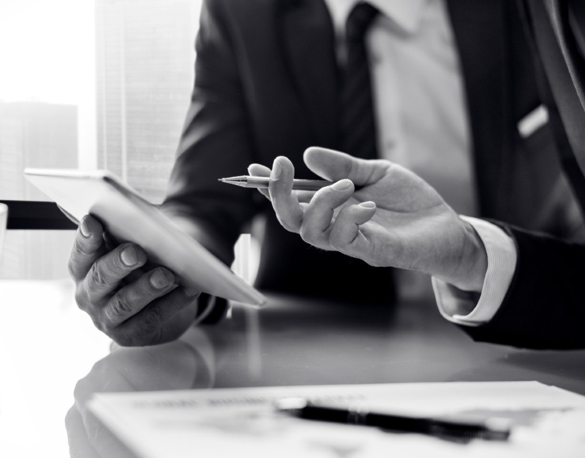 An immigration lawyer from WDM Legal Services reviewing documents in a modern office.